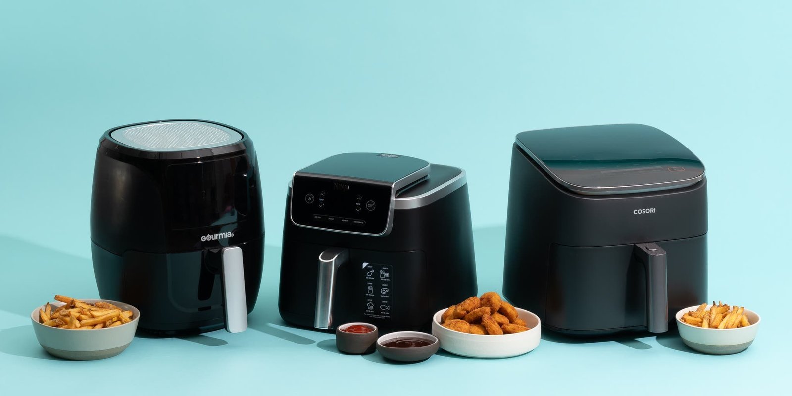 Modern air fryer on white quartz countertop with fresh vegetables and natural light