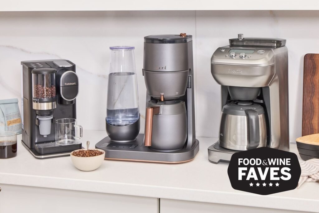 Sleek stainless steel coffee maker on wooden counter with morning light